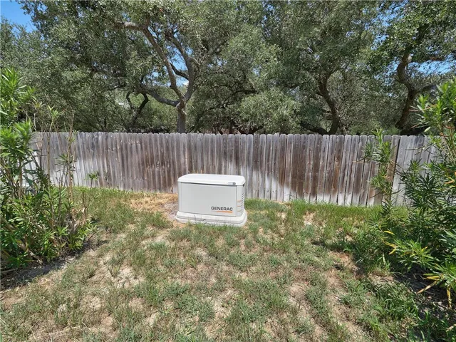 a view of a fence in the backyard