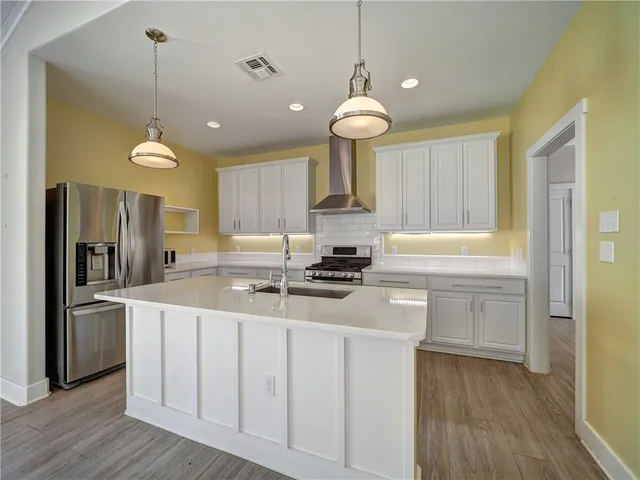 a kitchen with a sink stainless steel appliances and cabinets