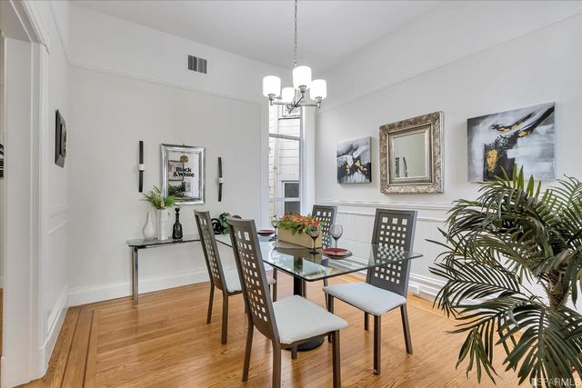 a view of a dining room with furniture and a chandelier