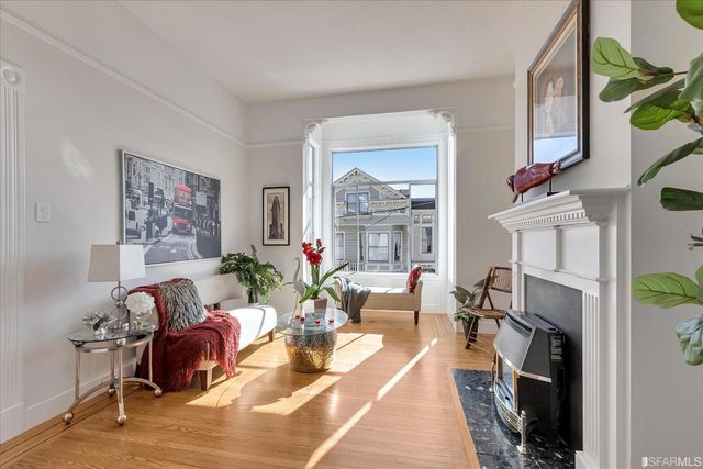 a living room with furniture a fireplace and a flat screen tv