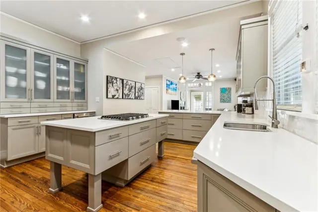 a large white kitchen with a stove and a sink