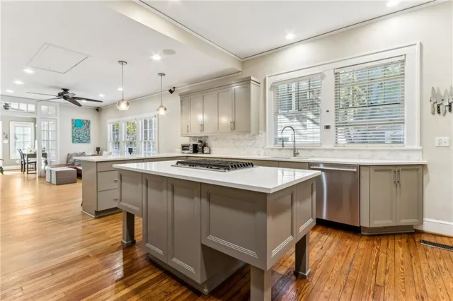 a kitchen with a sink stove and wooden cabinets