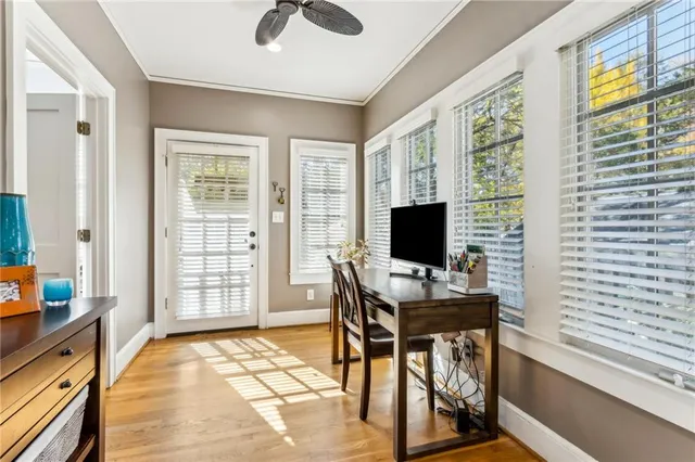 a view of a workspace with furniture and a window
