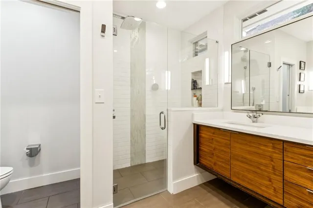 a bathroom with a double vanity sink a mirror and a shower
