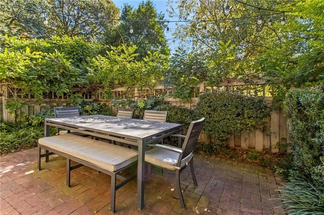 a backyard of a house with table and chairs