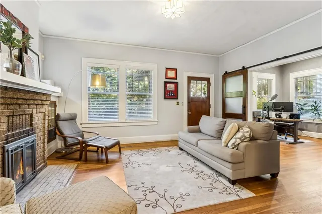 a living room with furniture and a fireplace