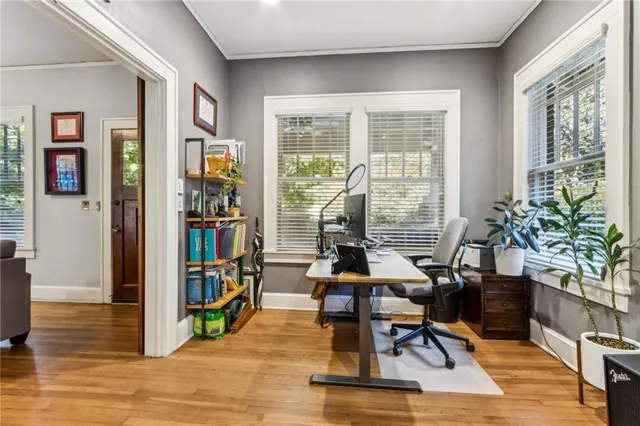 a view of a workspace with furniture and a potted plant
