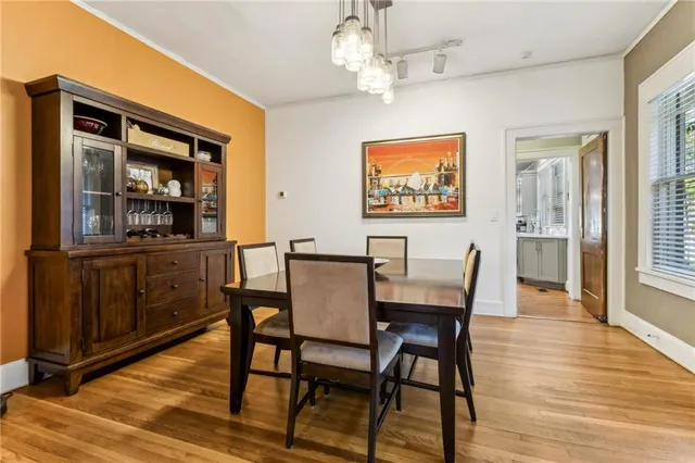 a view of a dining room with furniture wooden floor and a chandelier