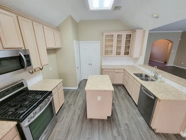 a kitchen with a sink stove and refrigerator