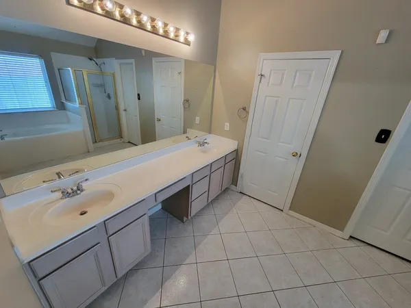 a spacious bathroom with a sink vanity and mirror