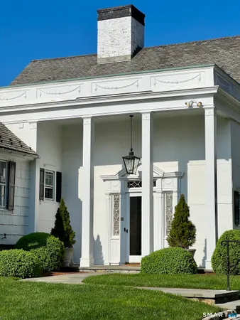 a front view of a house with a garden and plants