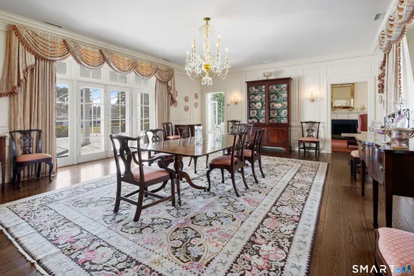 a living room with lots of wooden furniture and a large window