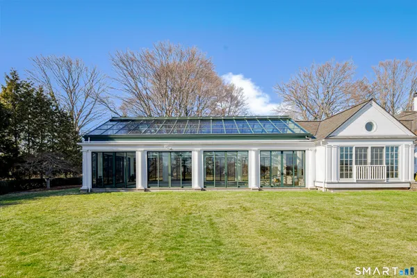a view of a patio with table and chairs with wooden floor and fence