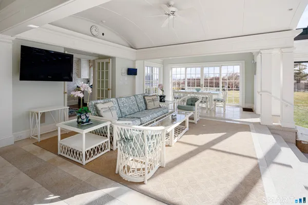 a living room with furniture and a book shelf