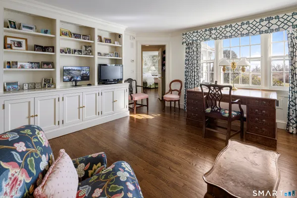 a spacious bedroom with a bed and a table in it