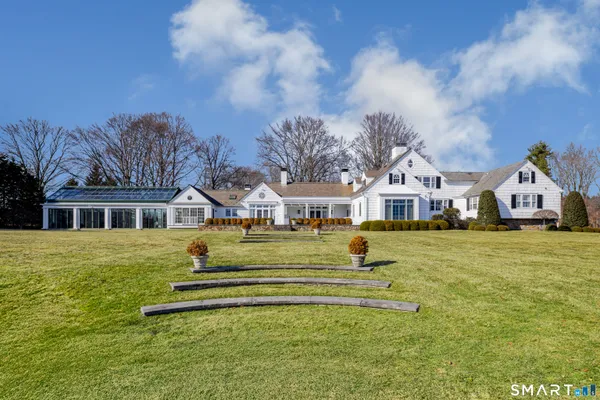 a front view of a house with a big yard