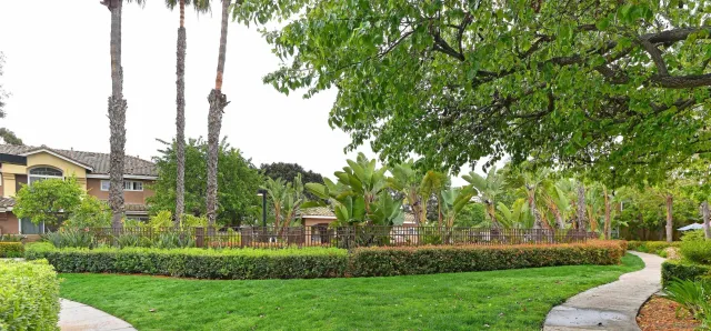 a view of backyard with swimming pool and seating space