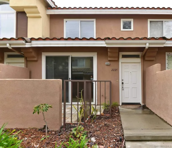 front view of a house with potted plants