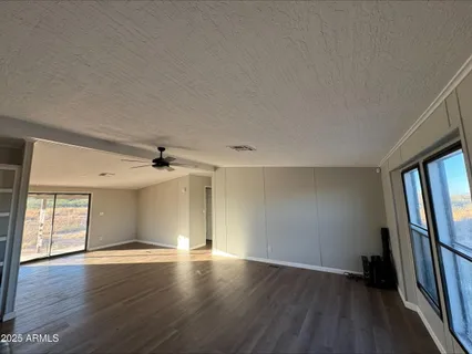 an empty room with wooden floor and a window
