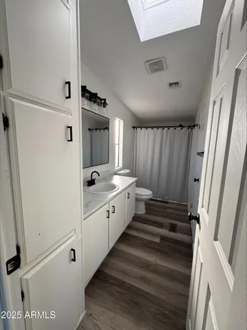 a large white room with a sink and a mirror