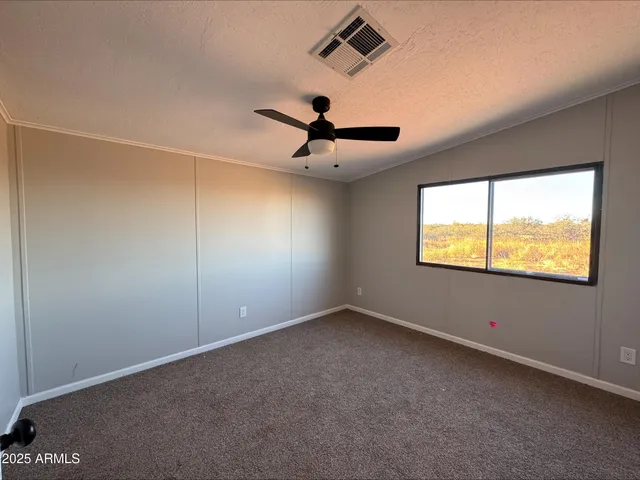 a view of room window and ceiling fan