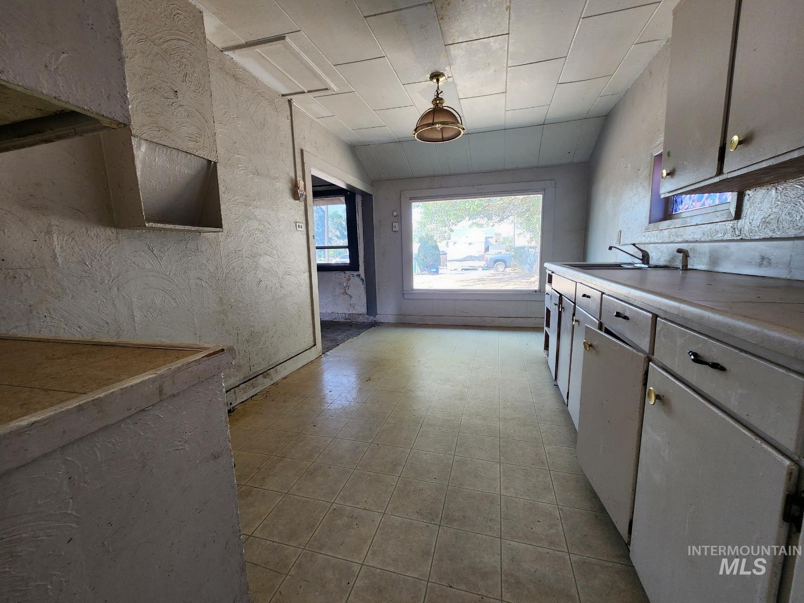 708 15th Avenue Lewiston, ID 83501 - Photo 4 of 12 Kitchen featuring light countertops and a textured wall