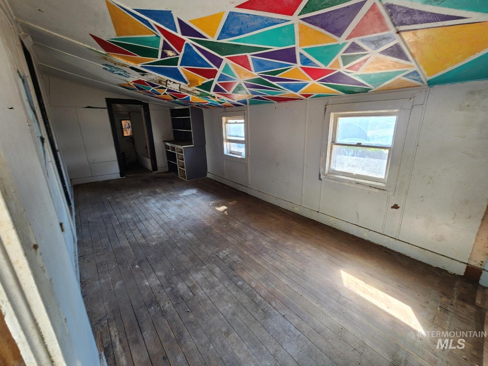 708 15th Avenue Lewiston, ID 83501 - Photo 5 of 12 Unfurnished dining area with wood-type flooring and vaulted ceiling