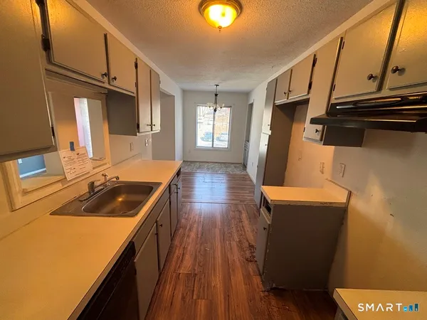a kitchen with wooden floor and a sink