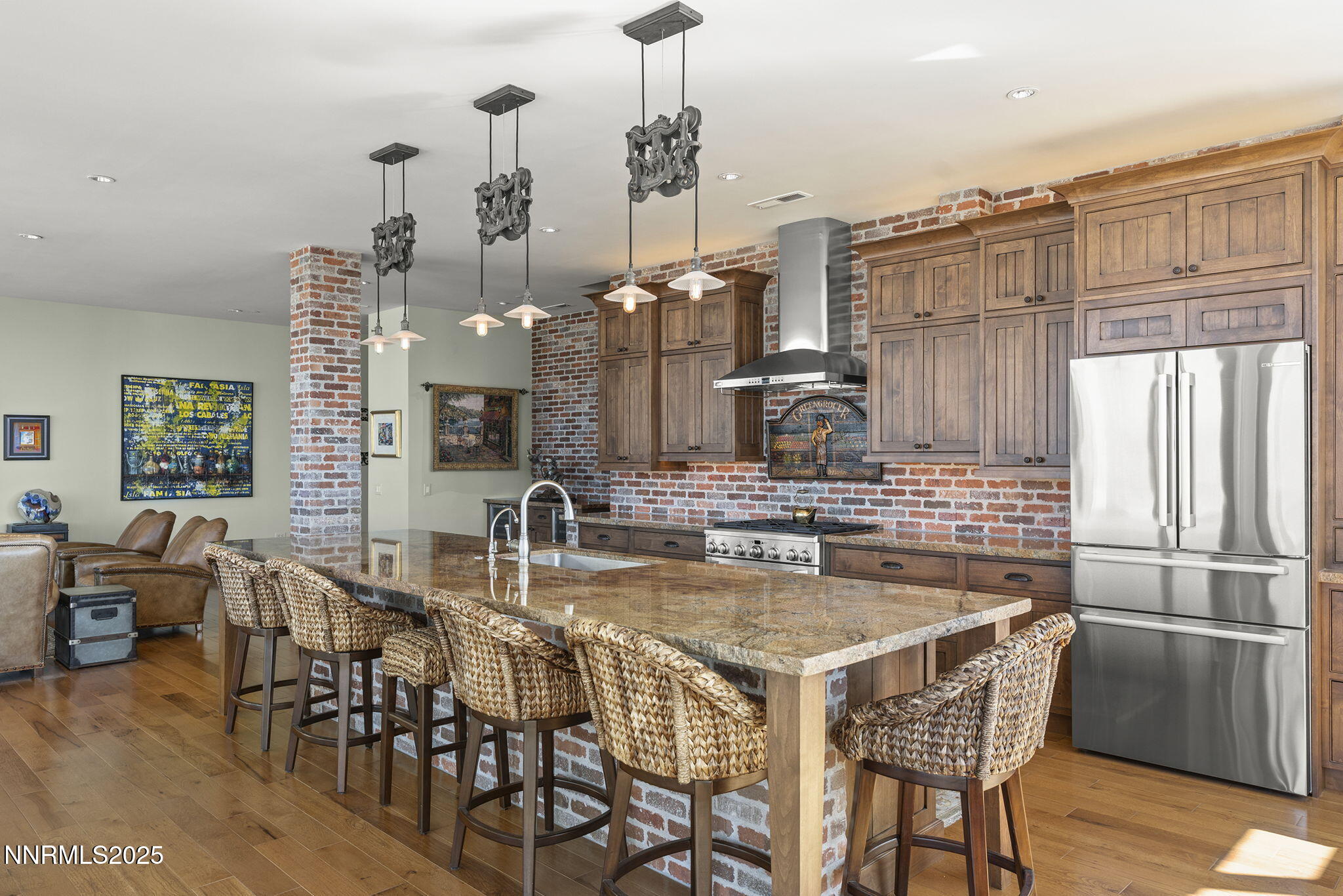 255 North Sierra Street, Unit 2303 Reno, NV 89501 - Photo 21 of 58 a kitchen with kitchen island granite countertop a dining table chairs sink and cabinets
