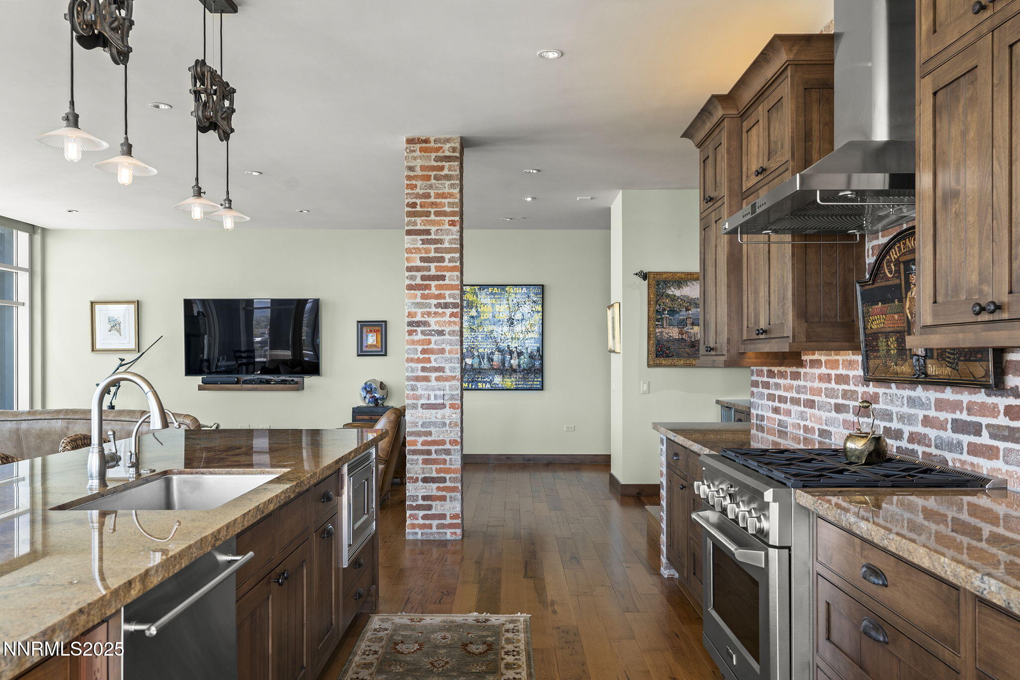 255 North Sierra Street, Unit 2303 Reno, NV 89501 - Photo 22 of 58 a kitchen with granite countertop a sink a stove and a wooden cabinets