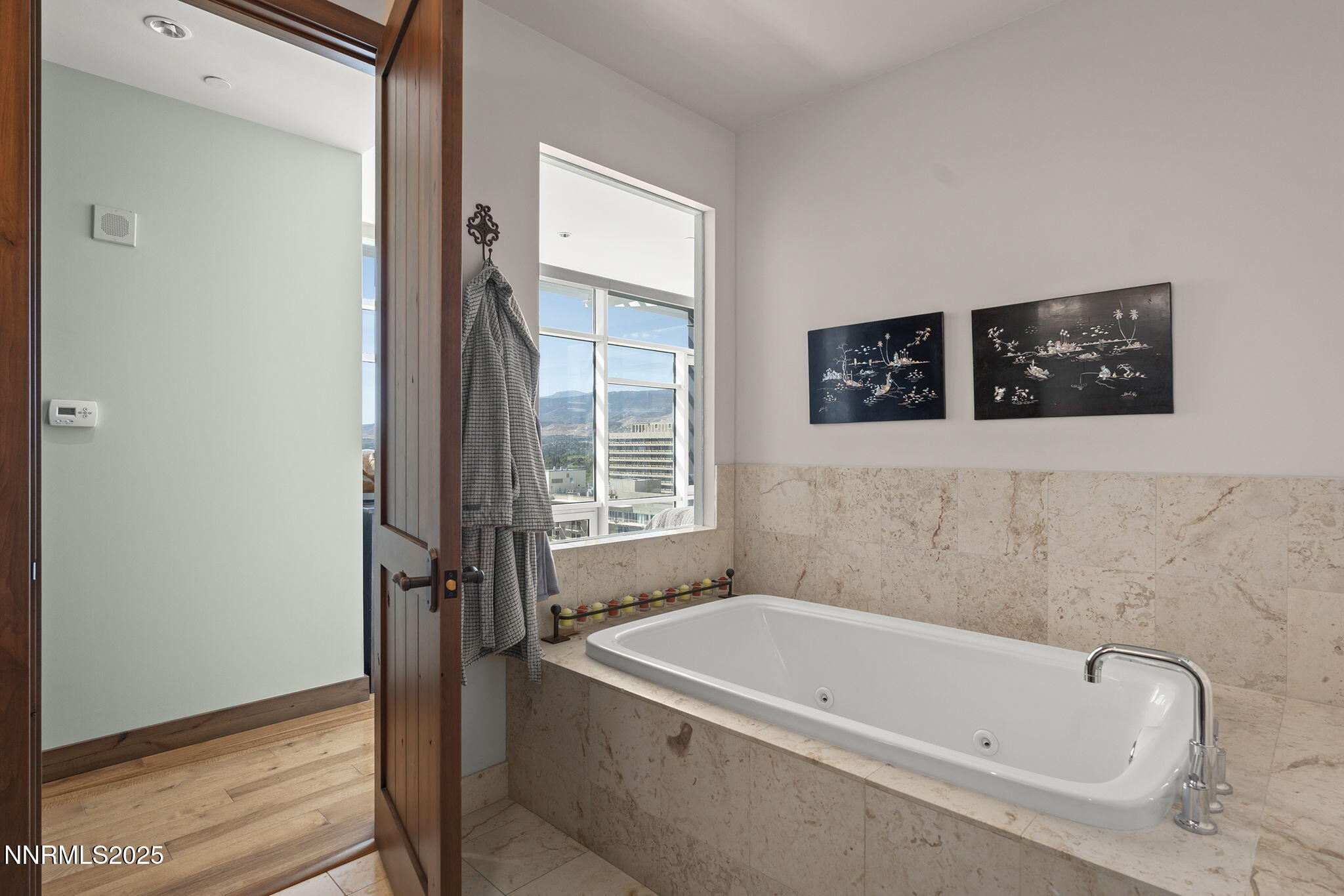 255 North Sierra Street, Unit 2303 Reno, NV 89501 - Photo 37 of 58 a bathroom with a tub a sink and a window