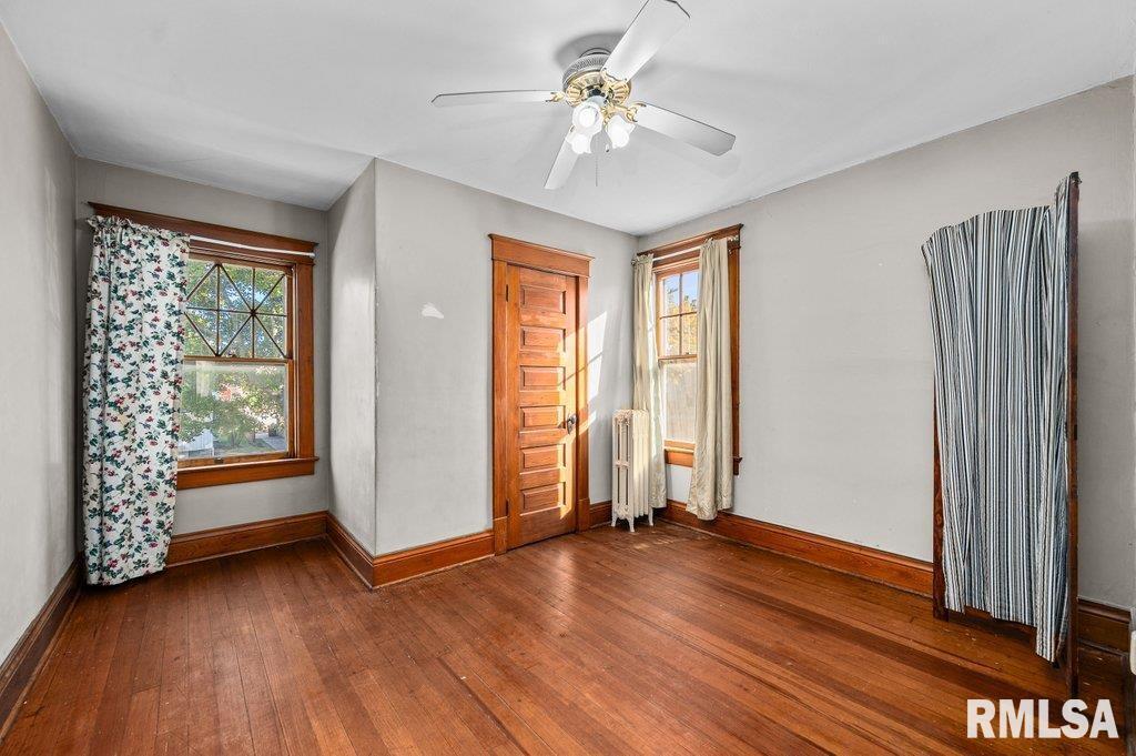 2105 15th Street Moline, IL 61265 - Photo 16 of 29 an empty room with wooden floor and windows