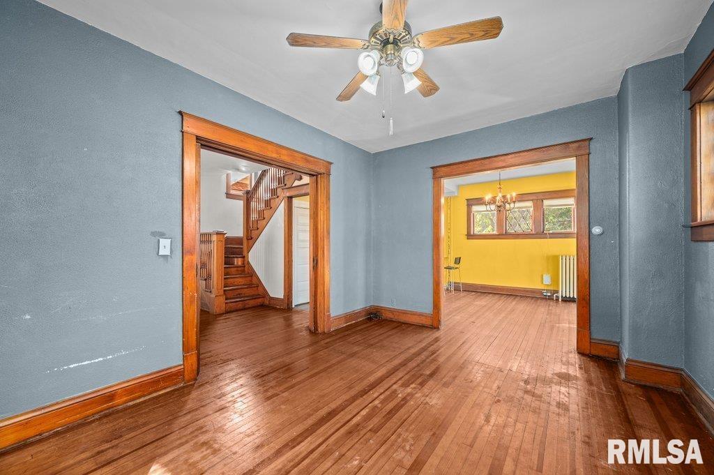 2105 15th Street Moline, IL 61265 - Photo 3 of 29 a view of an empty room with wooden floor and a window