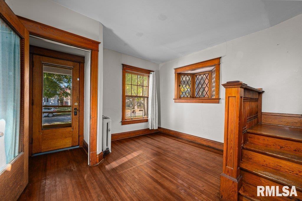 2105 15th Street Moline, IL 61265 - Photo 9 of 29 an empty room with wooden floor closet and windows