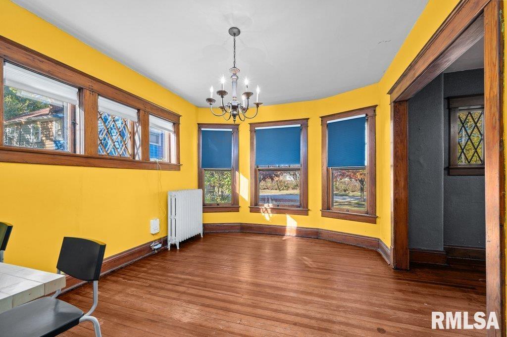 2105 15th Street Moline, IL 61265 - Photo 10 of 29 a view of an empty room with a window and wooden floor