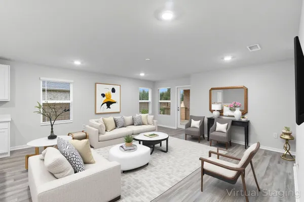 a view of kitchen with kitchen island wooden floors and stainless steel appliances