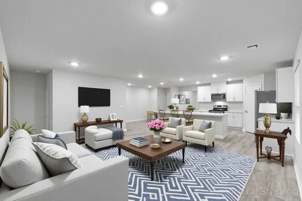 a kitchen with stainless steel appliances a stove a sink a microwave and cabinets