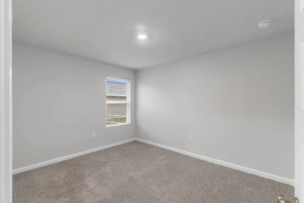 a bedroom with a bed and cabinets