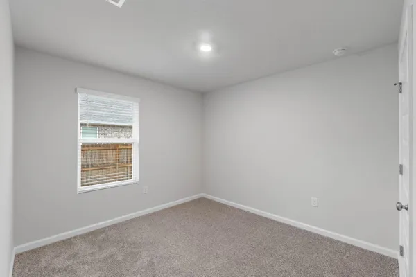 a bedroom with a bed and a potted plant