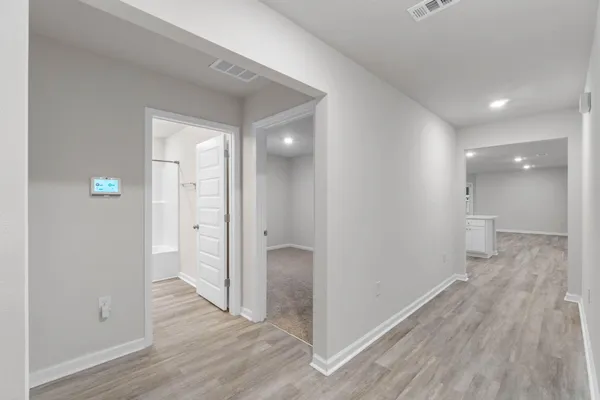 a large kitchen with a lot of counter space and wooden floor