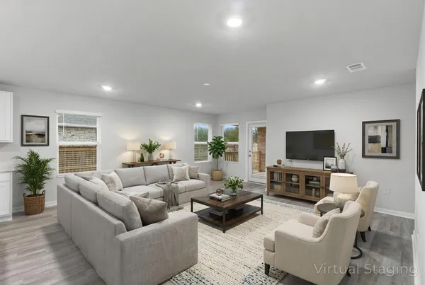 a living room with furniture and a wooden floor