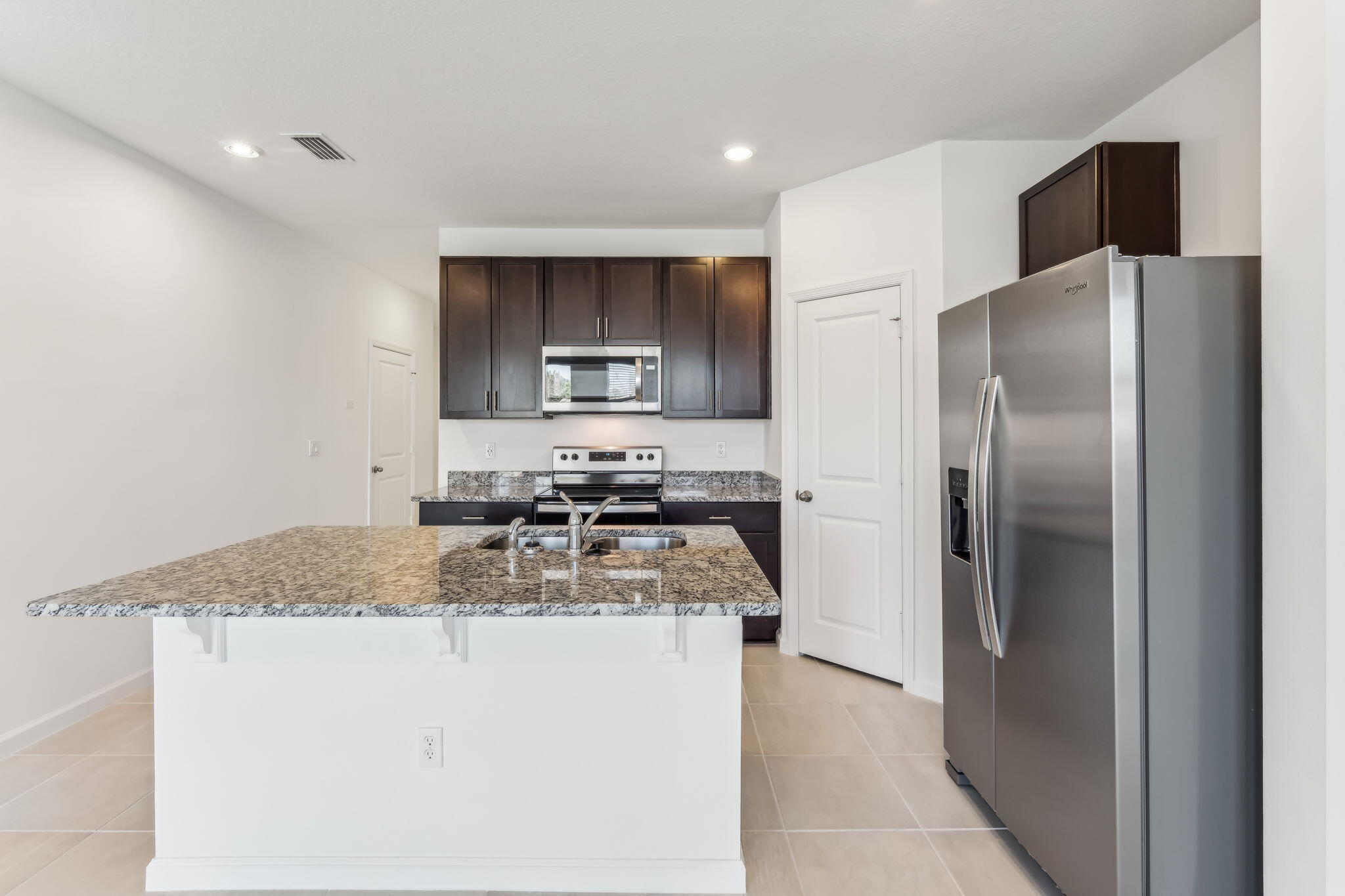 676 Salisbury Circle Fort Pierce, FL 34982 - Photo 11 of 31 a kitchen with stainless steel appliances granite countertop a refrigerator a stove a sink and a granite counter tops