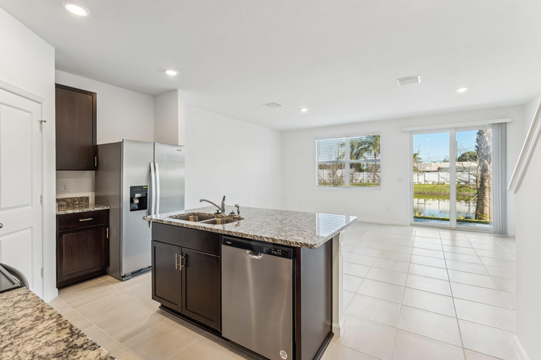 676 Salisbury Circle Fort Pierce, FL 34982 - Photo 12 of 31 a kitchen with stainless steel appliances granite countertop a sink stove and refrigerator