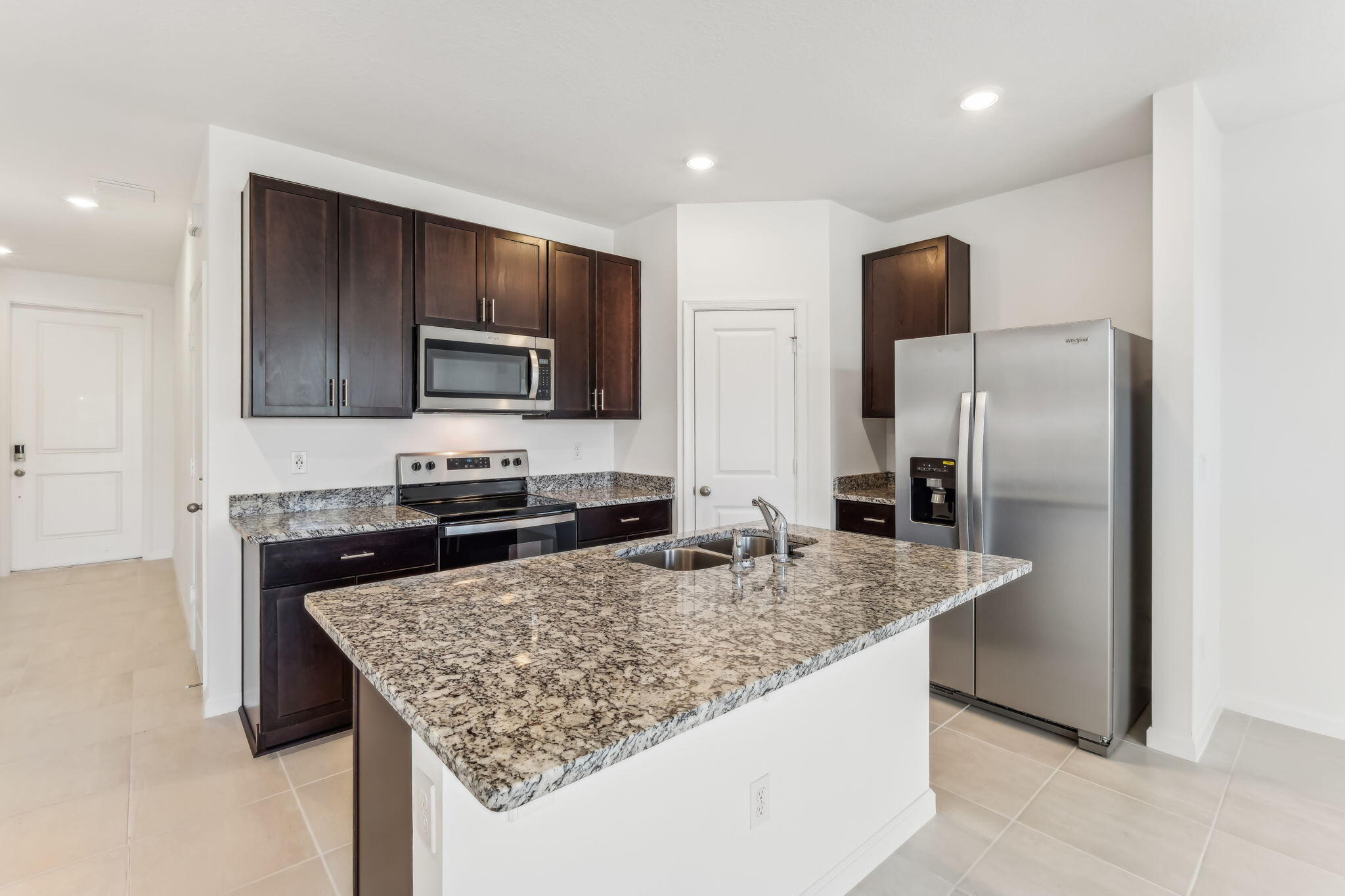 676 Salisbury Circle Fort Pierce, FL 34982 - Photo 14 of 31 a kitchen with stainless steel appliances granite countertop a sink refrigerator and microwave