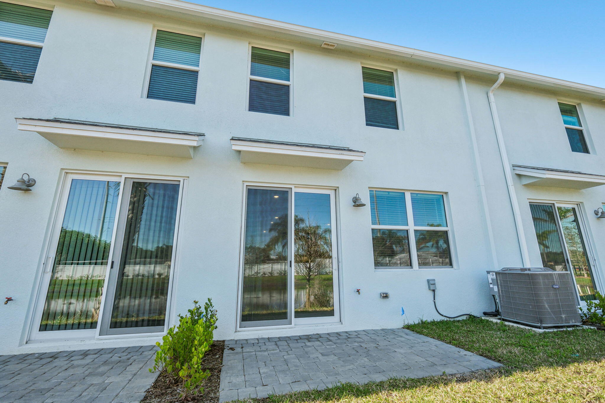 676 Salisbury Circle Fort Pierce, FL 34982 - Photo 31 of 31 a view of a brick house with plants and large tree