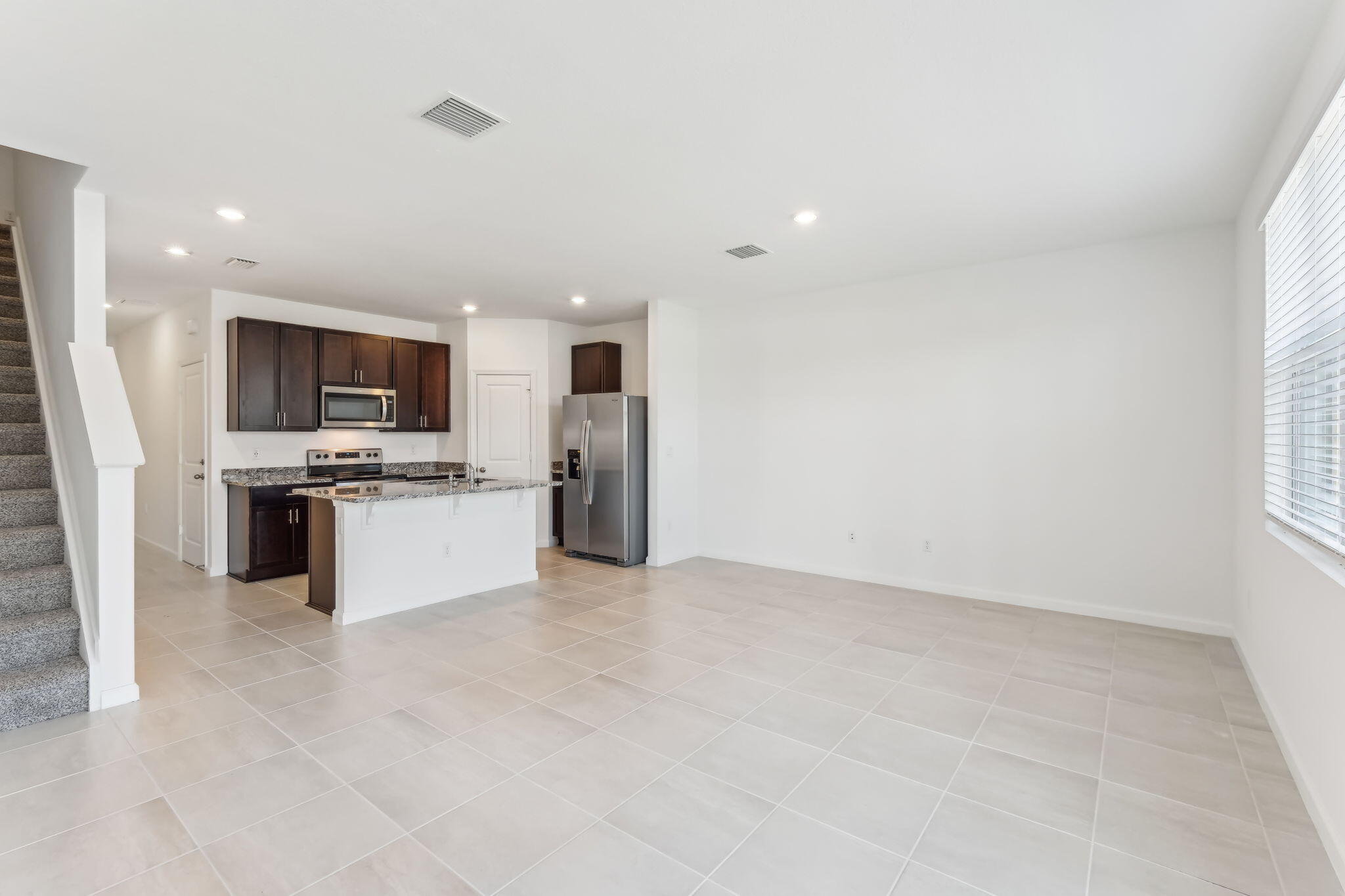 676 Salisbury Circle Fort Pierce, FL 34982 - Photo 7 of 31 a large kitchen with cabinets and stainless steel appliances