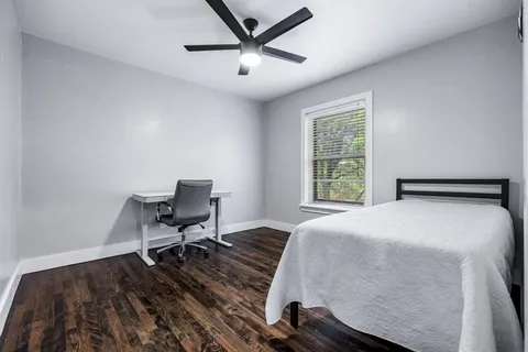 a bedroom with a bed and a desk