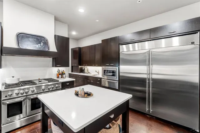 a kitchen with a stove a refrigerator and a sink