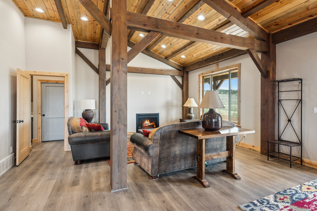 46997 West Thunder Road Fruitland, UT 84027 - Photo 6 of 49 Living room with a lit fireplace, light wood-style flooring, wooden ceiling, and recessed lighting