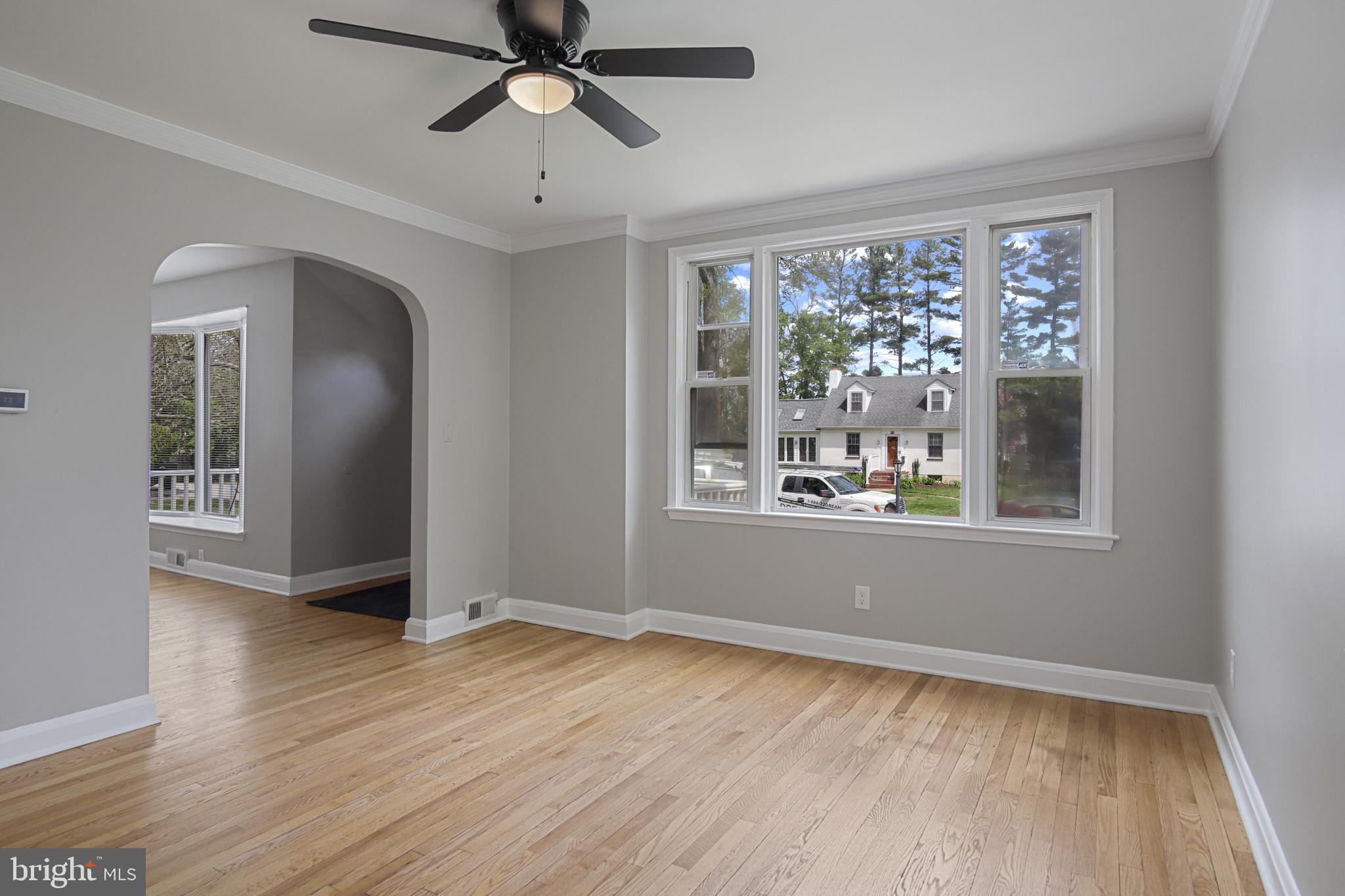 608 Farmhurst Road Baltimore, MD 21208 - Photo 13 of 45 a view of empty room with wooden floor and fan